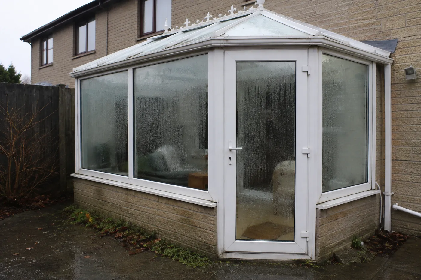 A closed conservatory in strong sun with the door shut