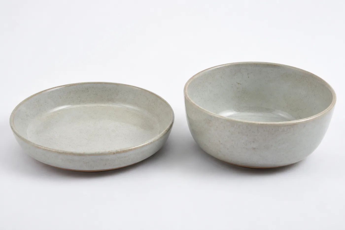A wide shallow dish beside a deep narrow bowl for comparison